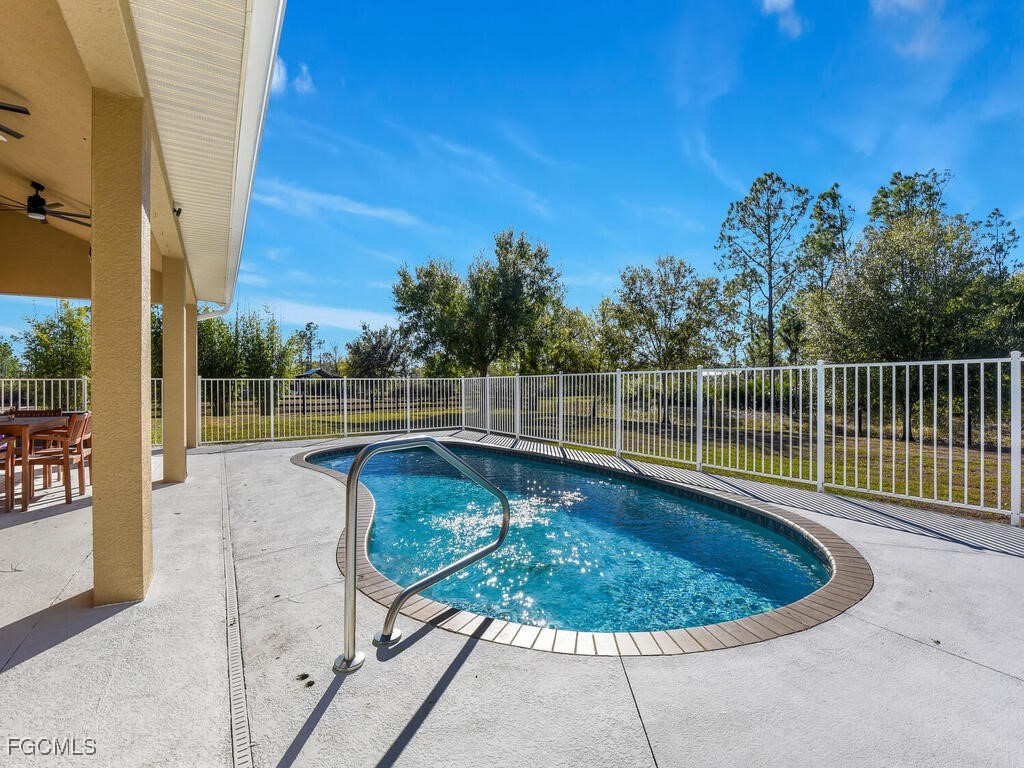 6041 Alan Boulevard Punta Gorda, FL 33982 - Photo 35 of 44 a view of a swimming pool with a patio and a yard