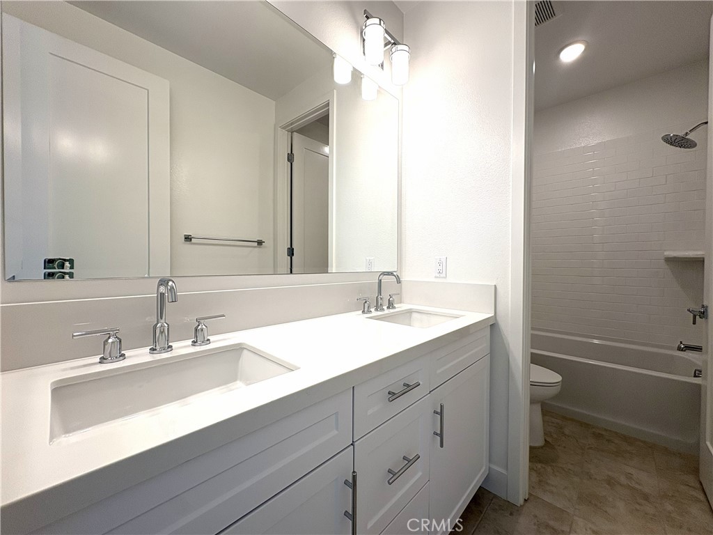 5168 Solace Drive Rancho Mission Viejo, CA 92694 - Photo 14 of 23 a bathroom with a double vanity sink toilet and a mirror