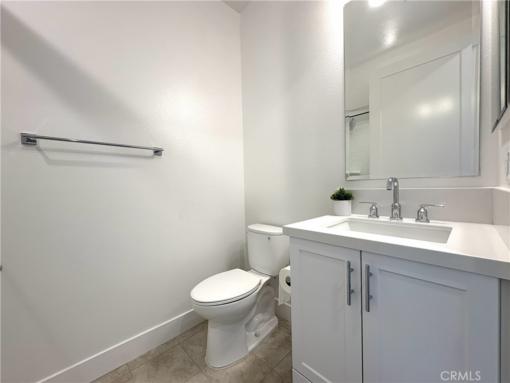5168 Solace Drive Rancho Mission Viejo, CA 92694 - Photo 15 of 23 a bathroom with a sink a toilet and a mirror