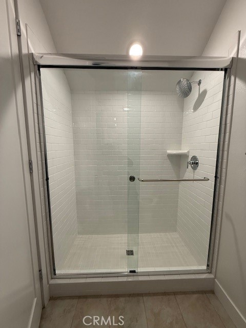 5168 Solace Drive Rancho Mission Viejo, CA 92694 - Photo 16 of 23 a bathroom with a glass shower door