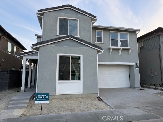 5168 Solace Drive Rancho Mission Viejo, CA 92694 - Photo 2 of 23 a front view of a house with a garage