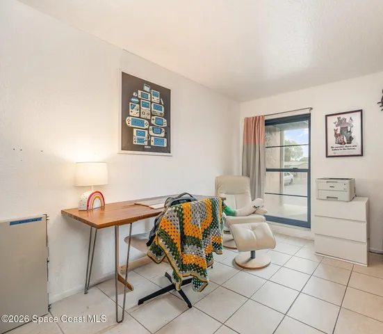 a living room with furniture a air conditioner vent and a window