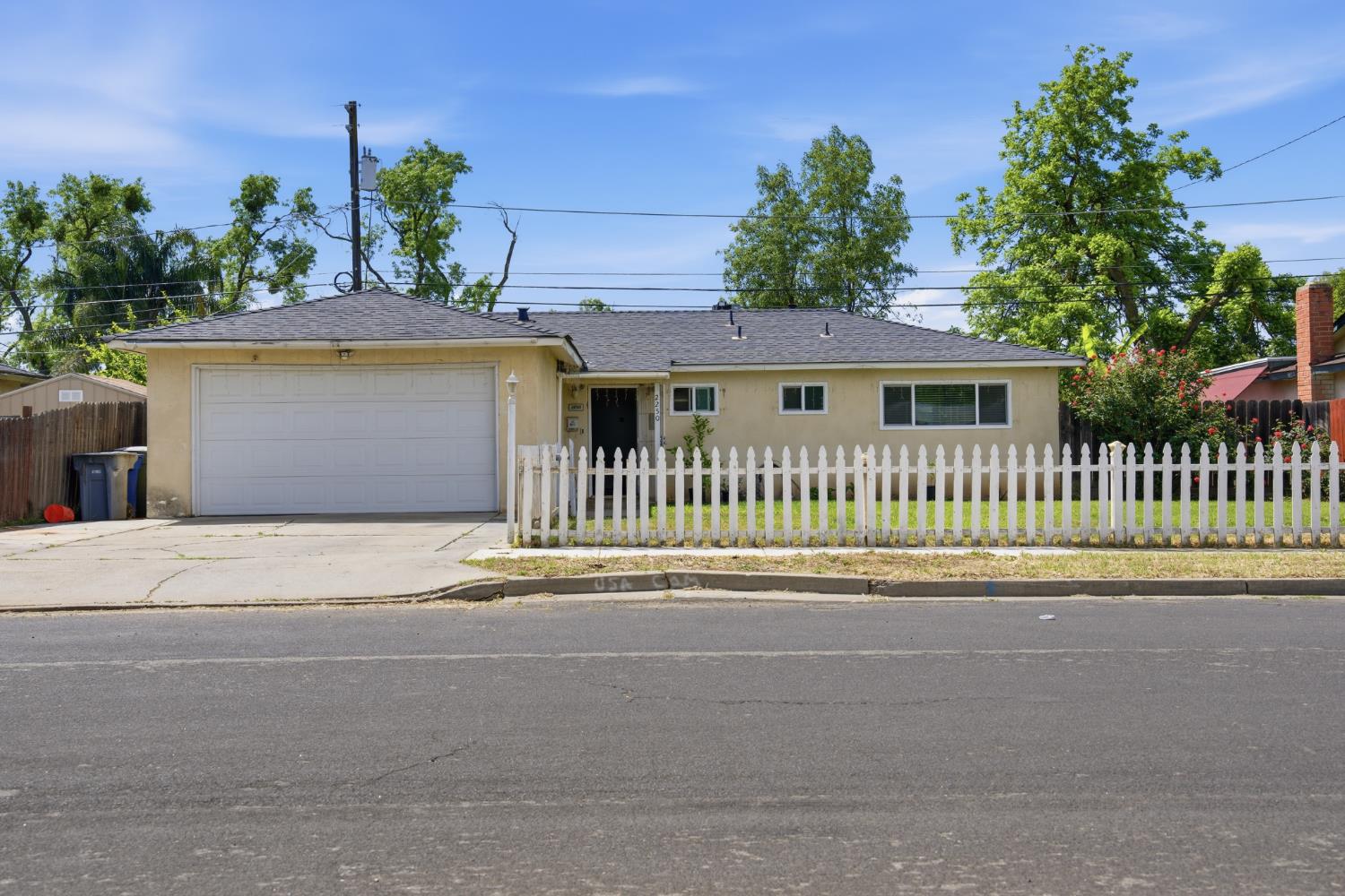 2250 Emerson Avenue Merced, CA 95341 - Photo 1 of 12 a front view of a house with a garden