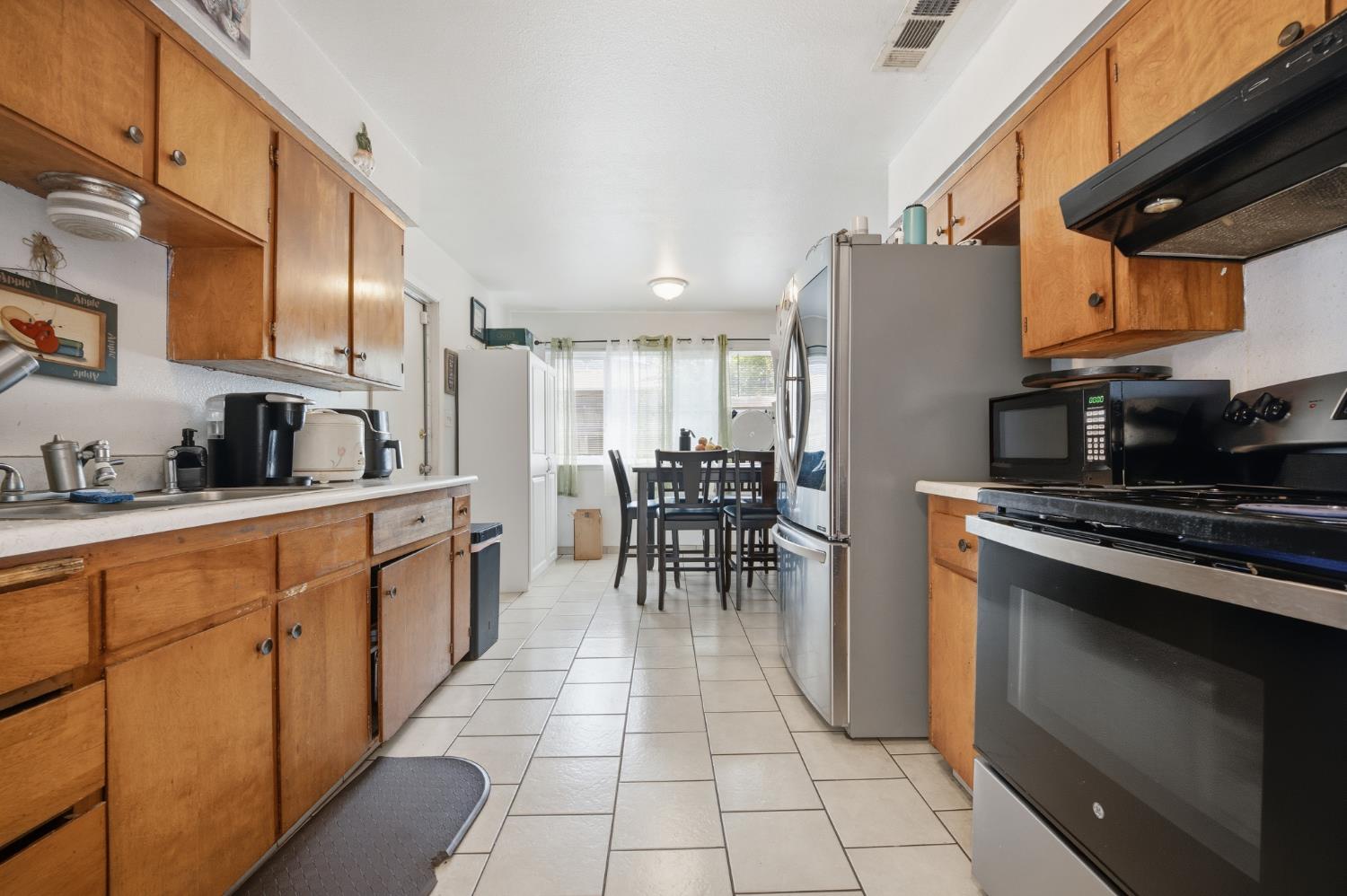 2250 Emerson Avenue Merced, CA 95341 - Photo 2 of 12 a kitchen with stainless steel appliances kitchen island granite countertop a stove a sink and a refrigerator