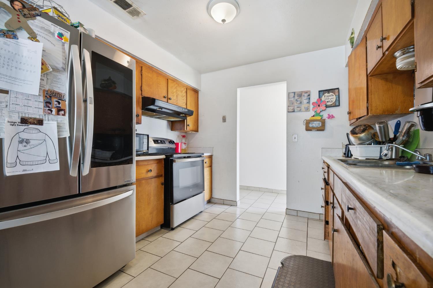 2250 Emerson Avenue Merced, CA 95341 - Photo 3 of 12 a kitchen with stainless steel appliances granite countertop a refrigerator and a stove top oven