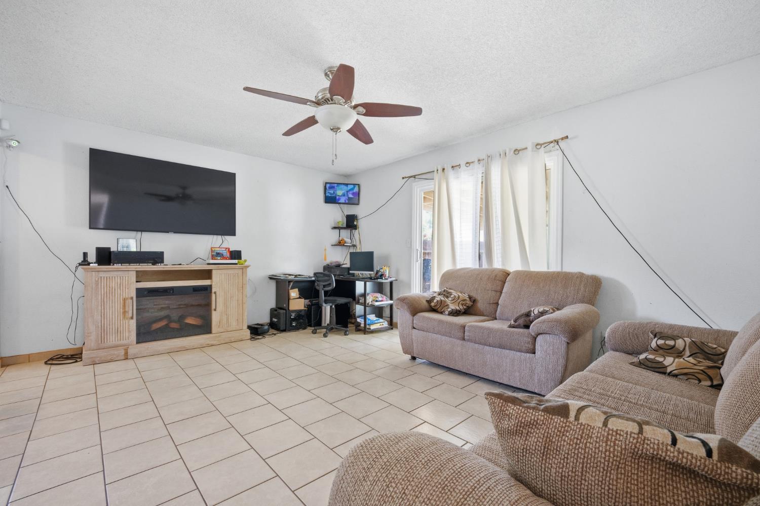 2250 Emerson Avenue Merced, CA 95341 - Photo 5 of 12 a living room with furniture and a flat screen tv