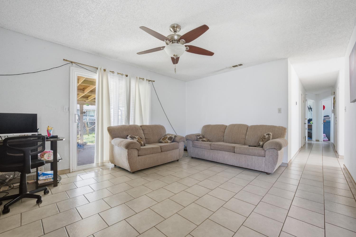 2250 Emerson Avenue Merced, CA 95341 - Photo 6 of 12 a living room with furniture and a flat screen tv