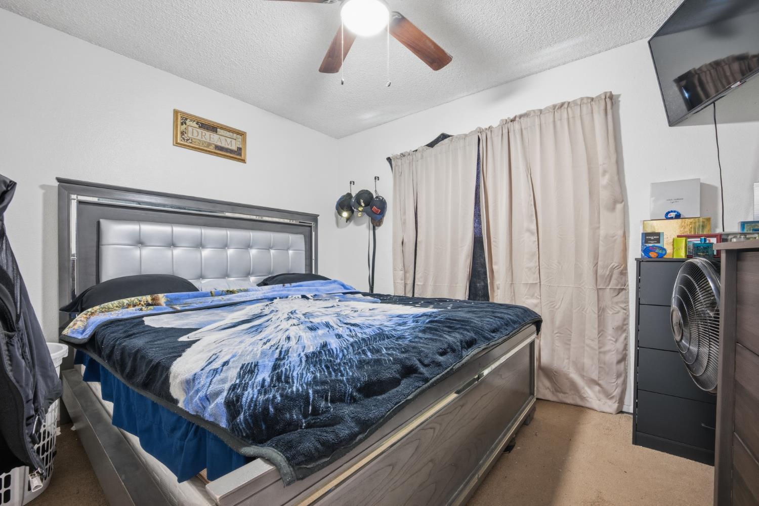2250 Emerson Avenue Merced, CA 95341 - Photo 7 of 12 a bedroom with a bed and a refrigerator