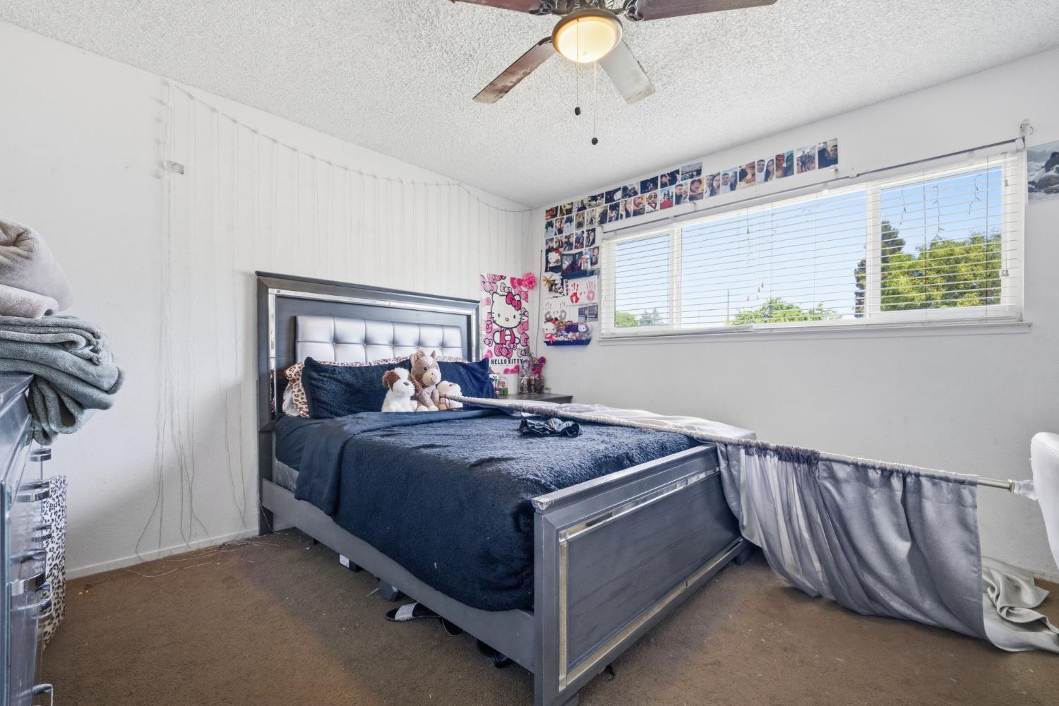 2250 Emerson Avenue Merced, CA 95341 - Photo 9 of 12 a bed room with a bed and a chandelier