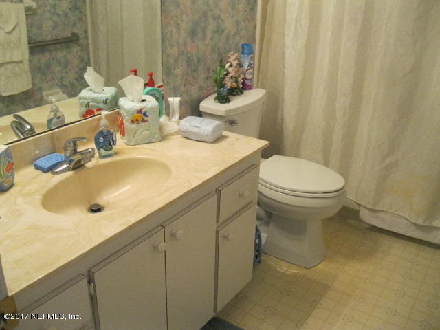 3405 Ricky Court Jacksonville, FL 32223 - Photo 13 of 15 a bathroom with a sink a toilet and shower curtain