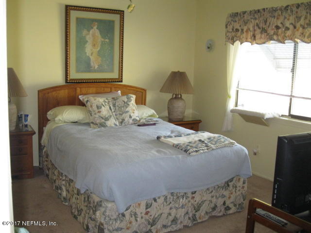 3405 Ricky Court Jacksonville, FL 32223 - Photo 9 of 15 a bedroom with a bed and wooden floor