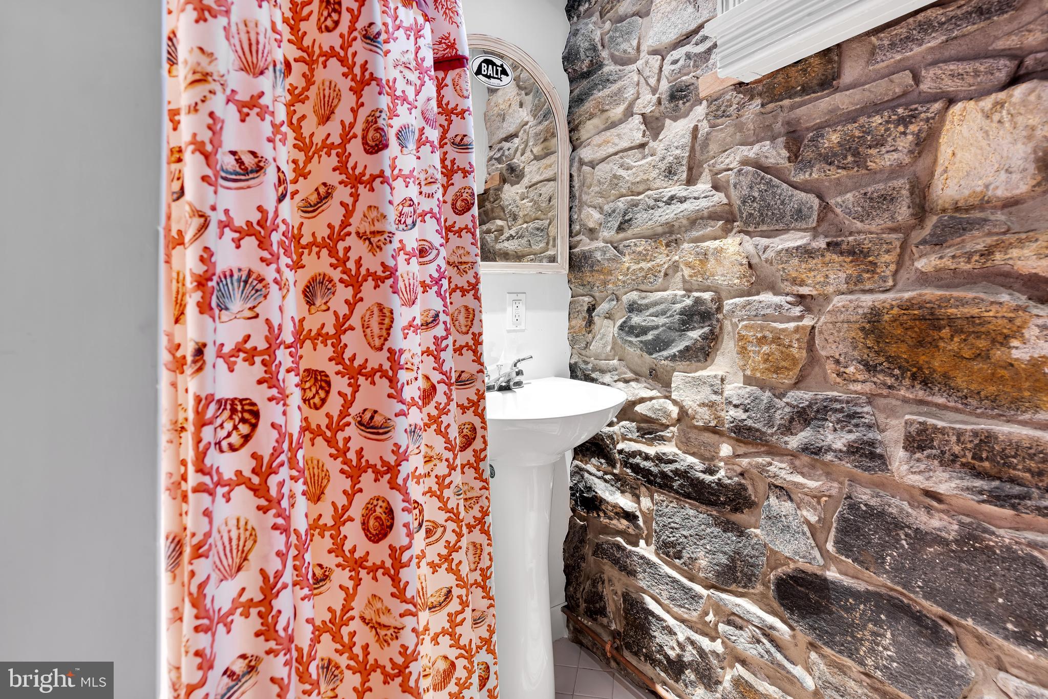 2 Hillside Road Baltimore, MD 21210 - Photo 69 of 79 a bathroom with a toilet and a shower curtain