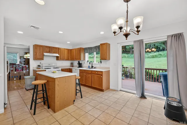a kitchen that has a lot of cabinets and wooden floor