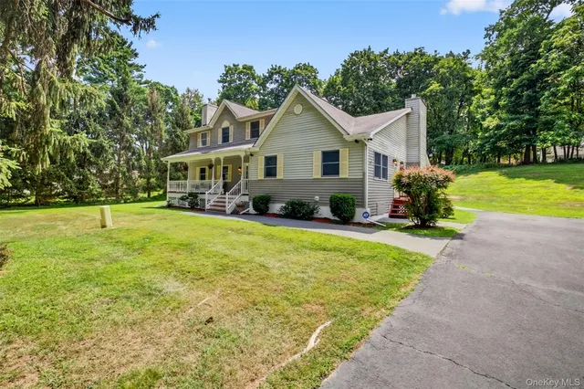 a front view of house with yard and green space