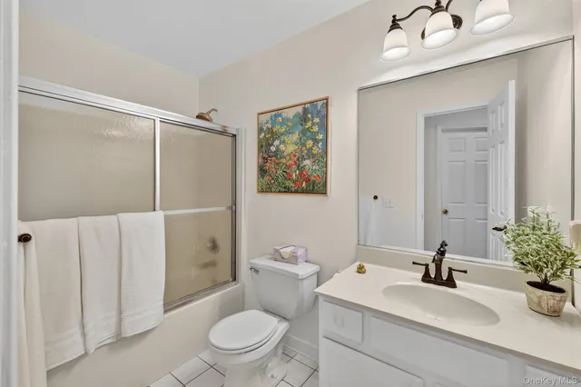 a spacious bathroom with a double vanity sink mirror and toilet
