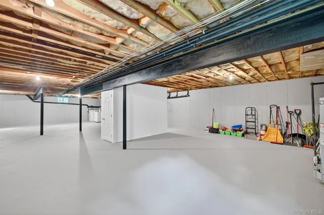 a view of a house with wooden deck and furniture