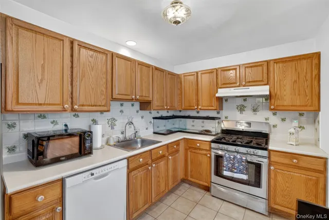 a kitchen with granite countertop cabinets stainless steel appliances a sink and a counter space