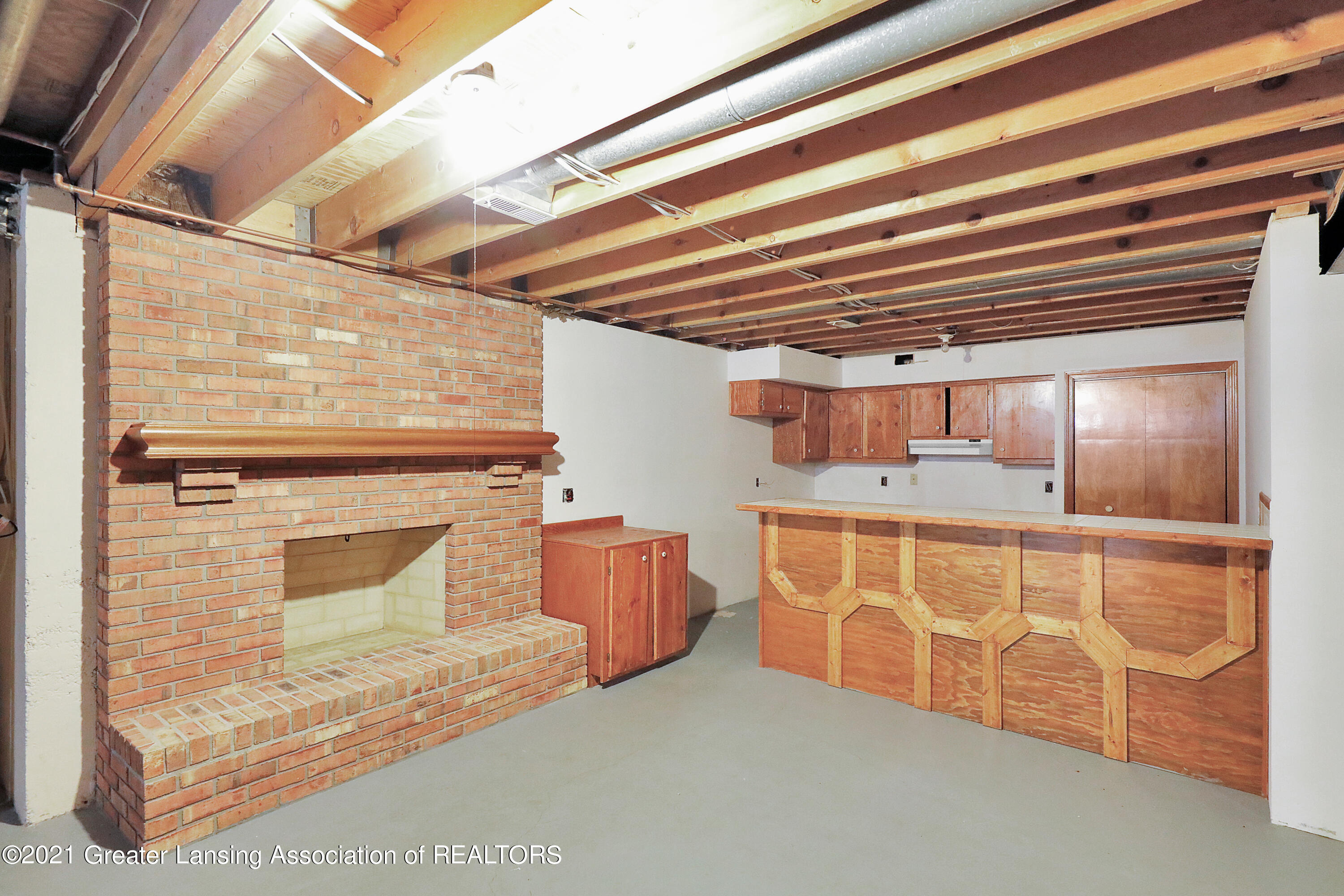 1494 Dennison Road East Lansing, MI 48823 - Photo 32 of 40 Basement Fireplace & Bar