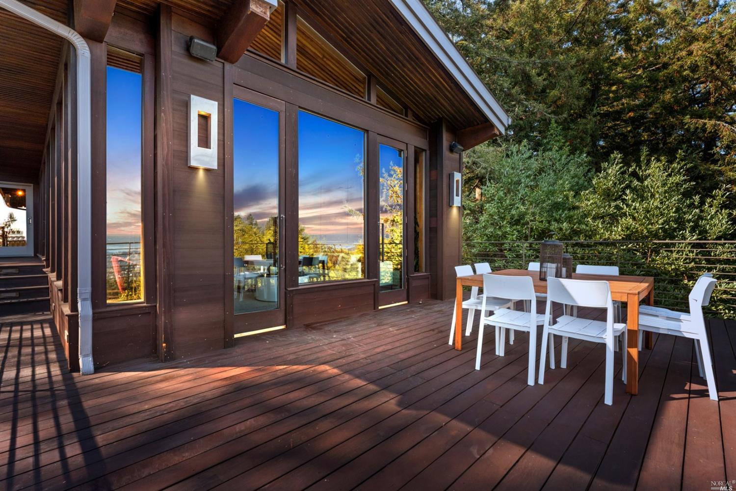 655 Edgewood Avenue Mill Valley, CA 94941 - Photo 12 of 85 a view of a patio with table and chairs with wooden floor and floor to ceiling window