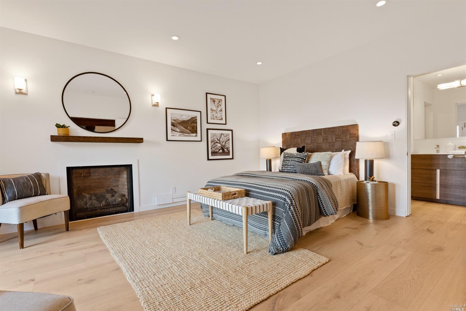 655 Edgewood Avenue Mill Valley, CA 94941 - Photo 22 of 85 a bedroom with a bed a dresser and a fireplace