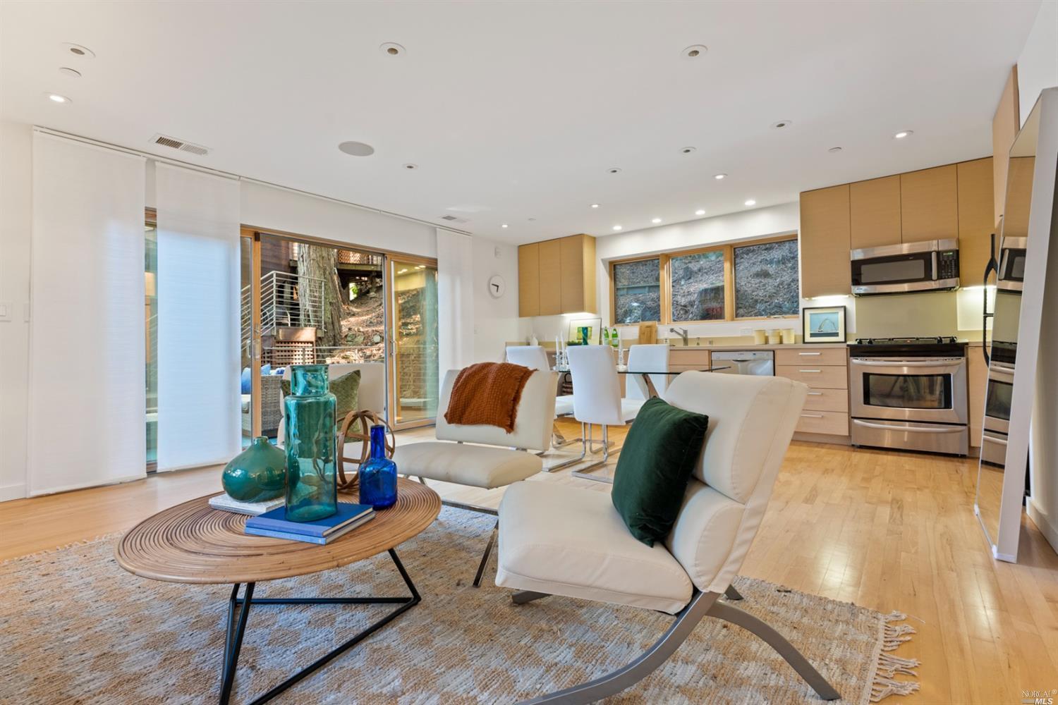 655 Edgewood Avenue Mill Valley, CA 94941 - Photo 74 of 85 a living room with furniture kitchen view and a wooden floor