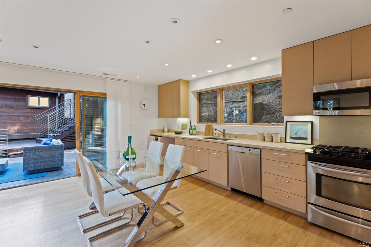 655 Edgewood Avenue Mill Valley, CA 94941 - Photo 75 of 85 a kitchen with a table chairs microwave and cabinets