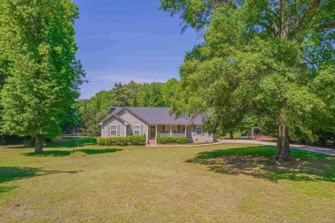857 Hays Road Carnesville, GA 30521 - Photo 1 of 1 a house view with a play ground and large trees
