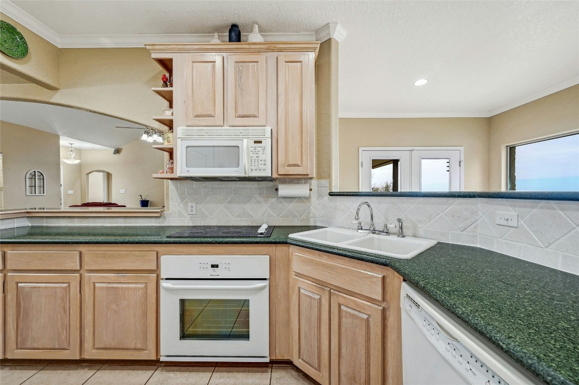 1370 Sunset View Fischer, TX 78623 - Photo 11 of 28 a kitchen with granite countertop a sink and cabinets