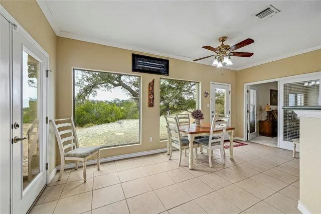 a view of a livingroom with furniture and a dining table with wooden floor