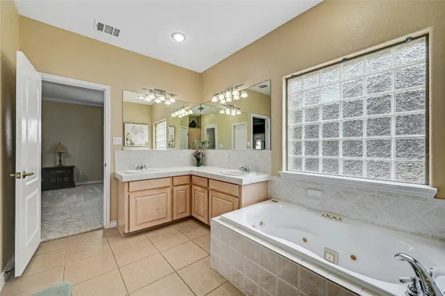 a large bathroom with a large tub sink and double vanity