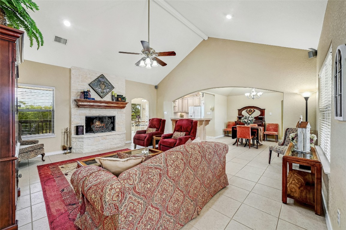 1370 Sunset View Fischer, TX 78623 - Photo 4 of 28 a living room with furniture a fireplace and gym equipment