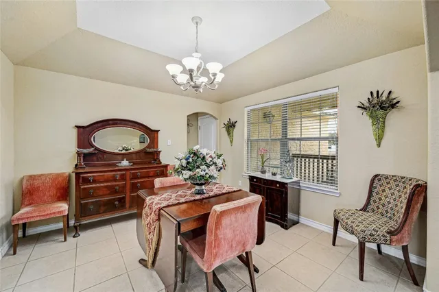 a living room with kitchen island furniture and a chandelier