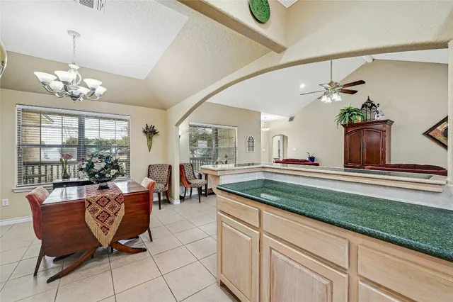 a kitchen with granite countertop a sink and cabinets