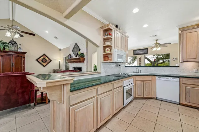 a kitchen with granite countertop a sink and cabinets