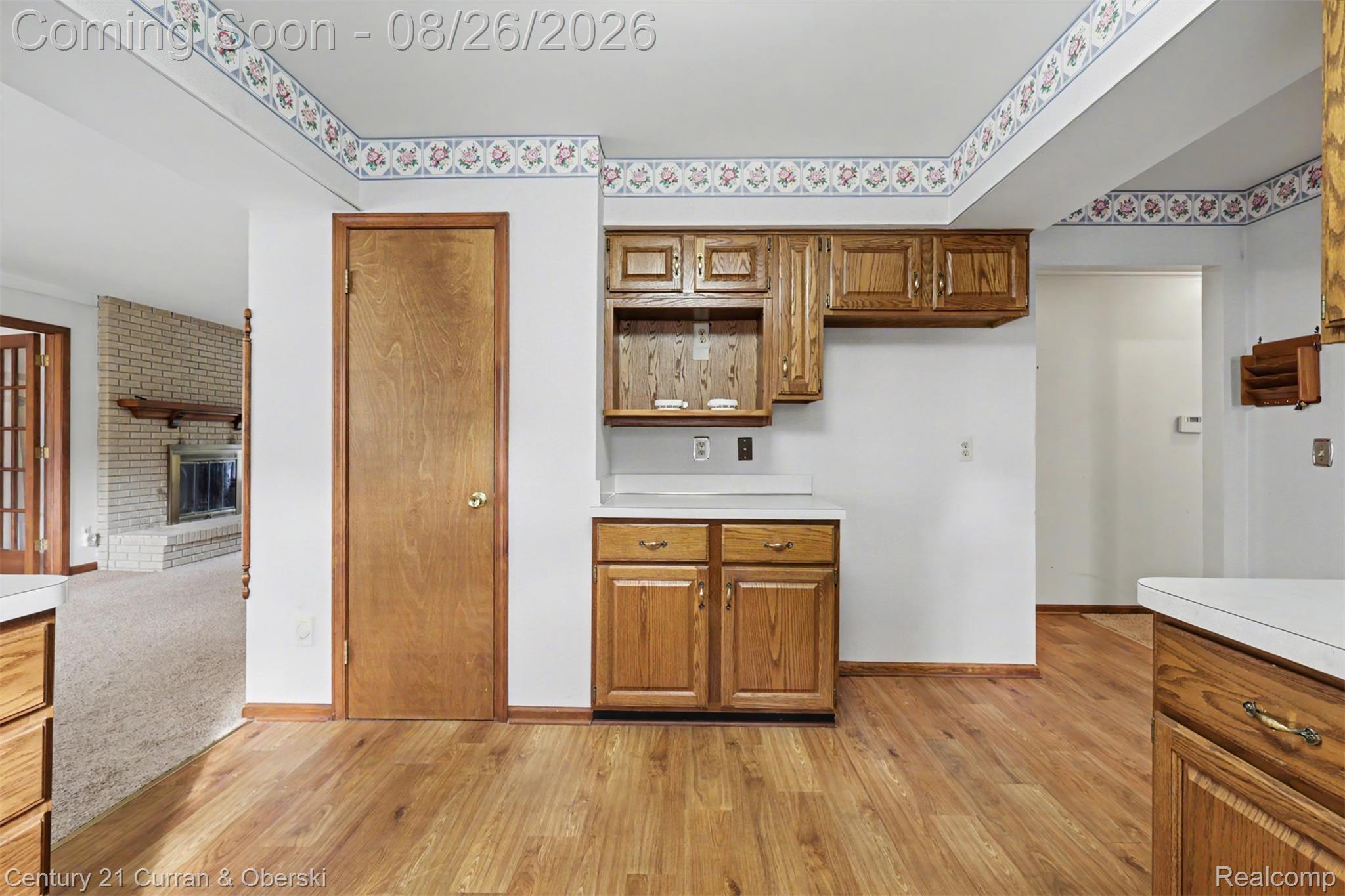 18227 Meridian Road Grosse Ile, MI 48138 - Photo 6 of 23 Wood-finish flooring throughout, complemented by wood cabinetry and white countertops