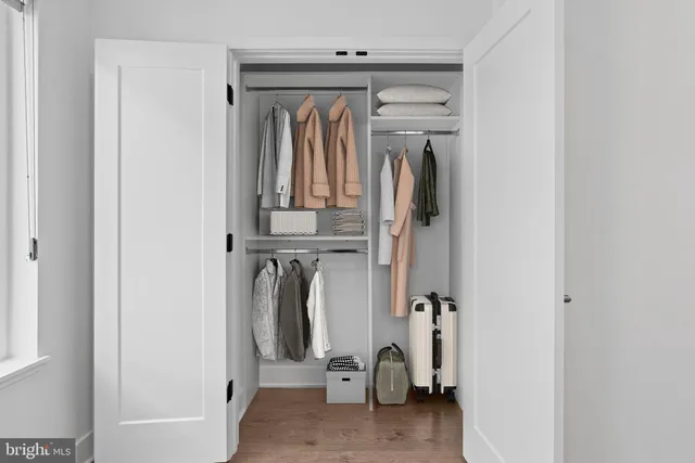 a view of walk in closet with clothes