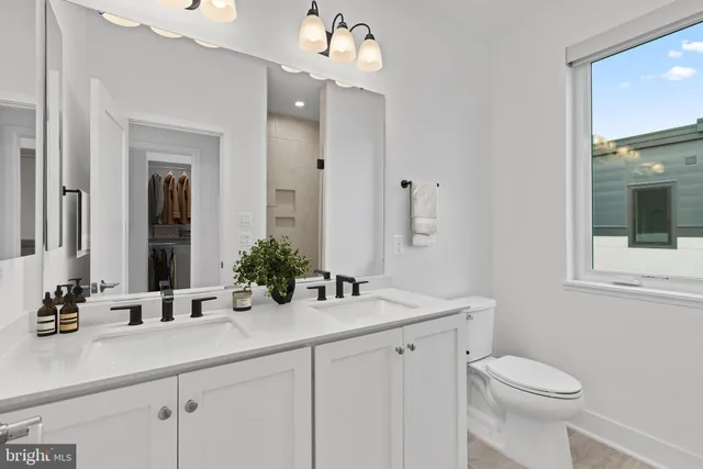 a bathroom with a sink a mirror and a toilet