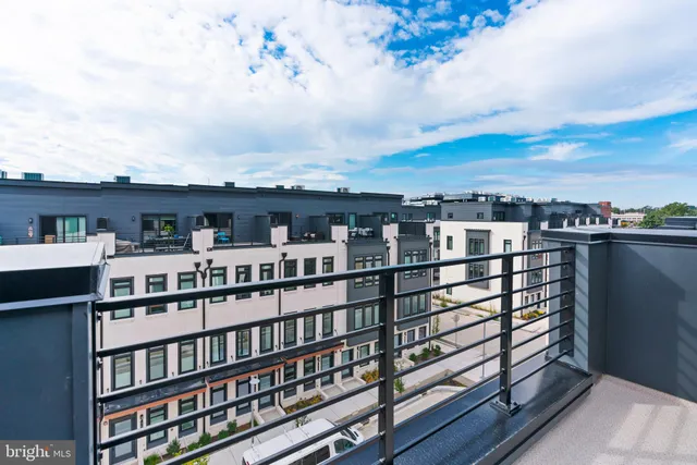 a view of a city that has tall buildings and a bench