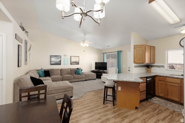 161 West 950 South, Unit S4 St. George, UT 84770 - Photo 21 of 21 Kitchen with lofted ceiling, a peninsula, open floor plan, light wood-style flooring, and a breakfast bar area