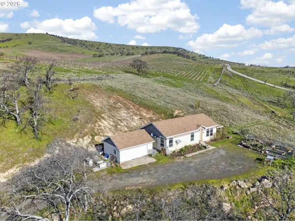 a view of a house with a yard and sitting area