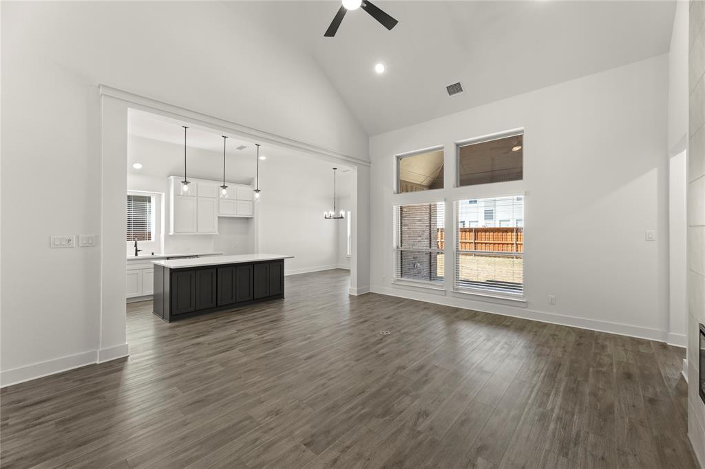 1314 Comal Drive Forney, TX 75126 - Photo 11 of 30 an empty room with wooden floor and windows