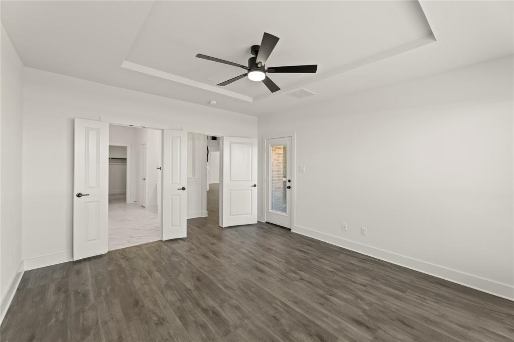 1314 Comal Drive Forney, TX 75126 - Photo 16 of 30 a view of empty room with wooden floor and ceiling fan