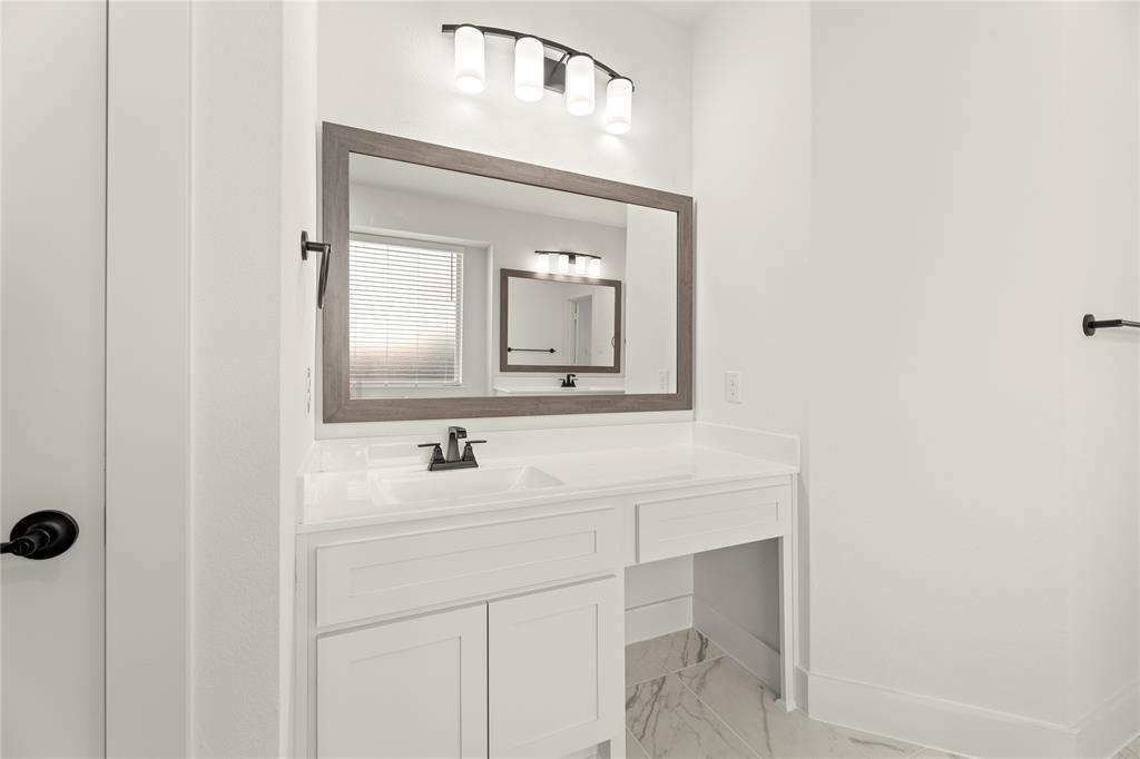 1314 Comal Drive Forney, TX 75126 - Photo 19 of 30 a bathroom with a sink vanity and a mirror