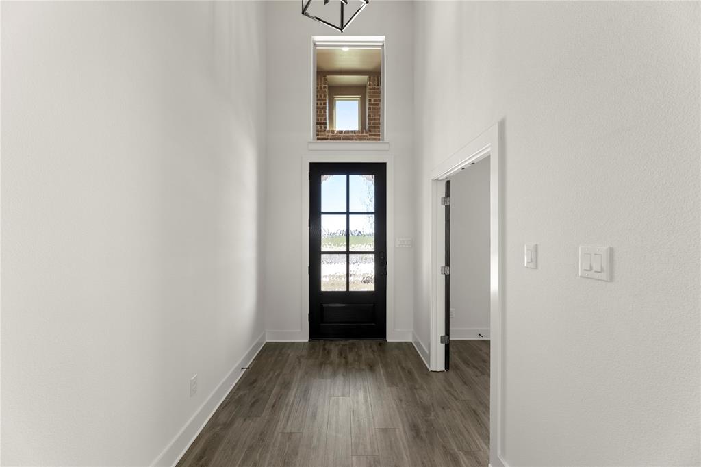 1314 Comal Drive Forney, TX 75126 - Photo 3 of 30 an empty room with wooden floor and windows