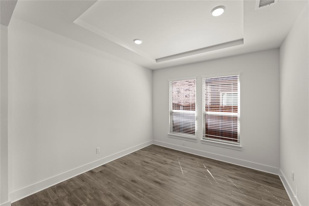 1314 Comal Drive Forney, TX 75126 - Photo 5 of 30 an empty room with wooden floor and windows