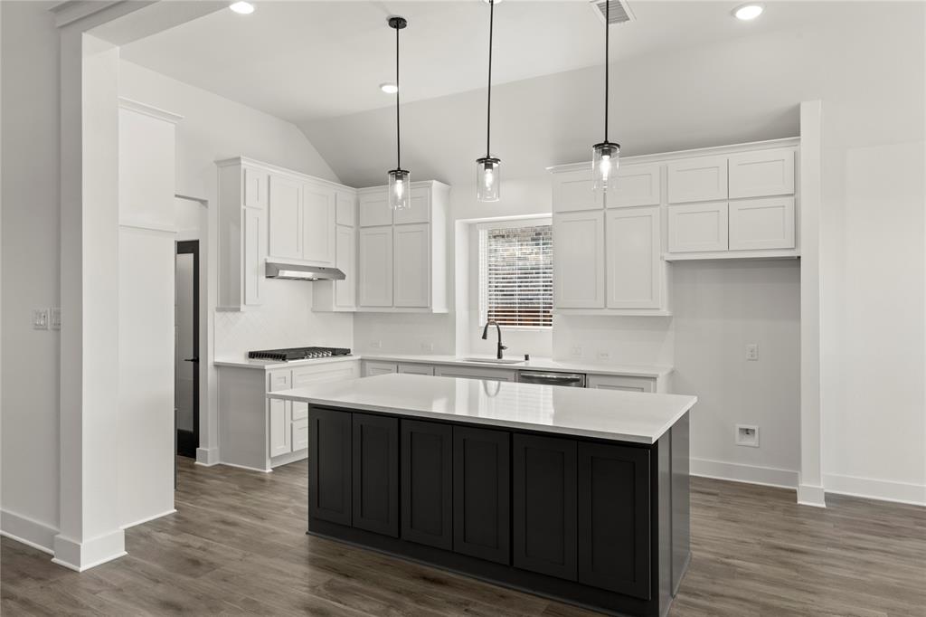 1314 Comal Drive Forney, TX 75126 - Photo 8 of 30 a kitchen with stainless steel appliances a sink a stove a refrigerator and white cabinets with wooden floor
