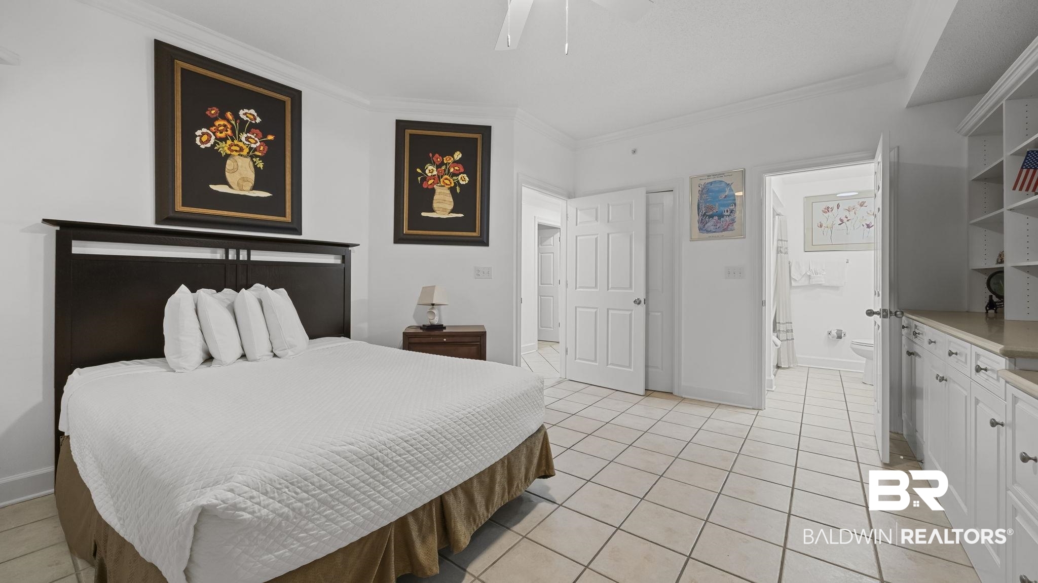27580 Canal Road, Unit 1213 Orange Beach, AL 36561 - Photo 16 of 27 Spacious room featuring neutral-toned tile flooring, white walls, built-in shelving, and white cabinetry with a light-colored countertop