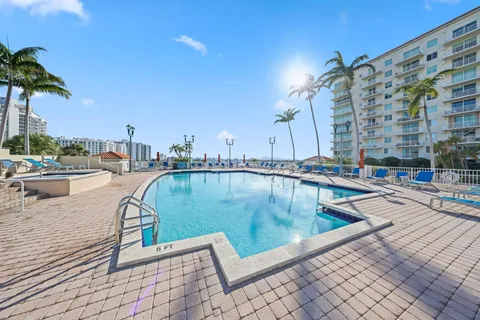 a view of a city with tall buildings and a big yard