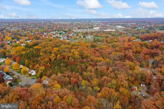 an aerial view of residential houses with city view