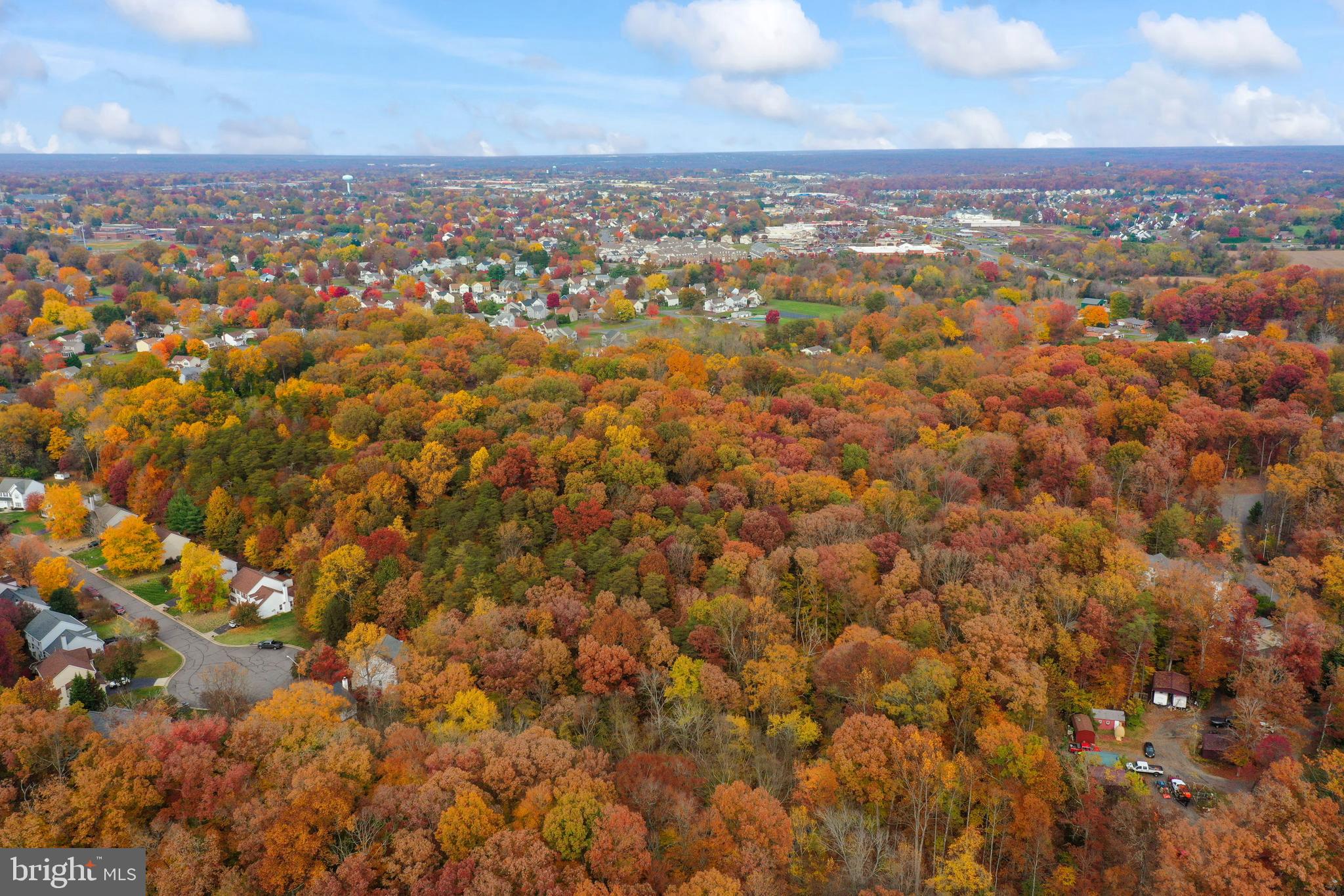 an aerial view of residential houses with city view